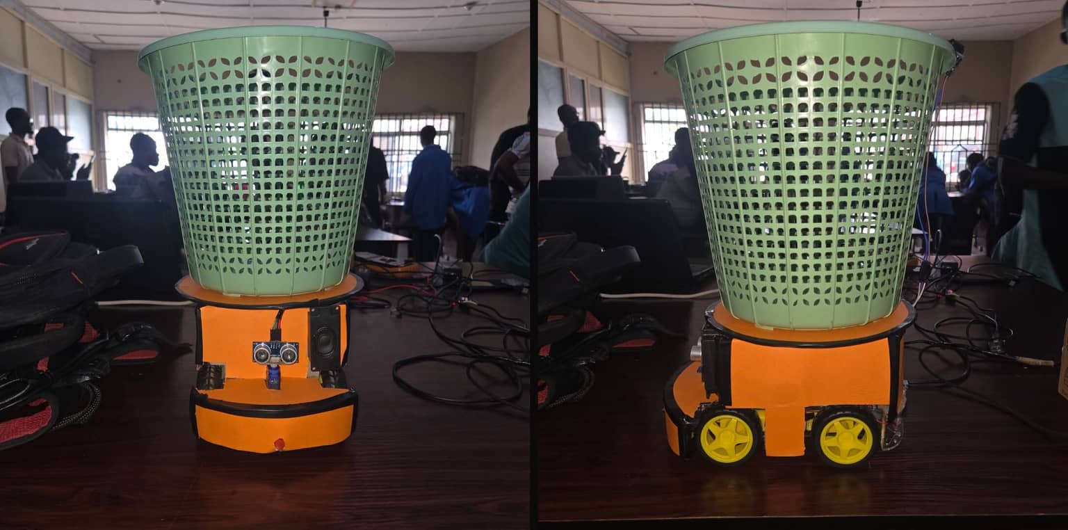 Elvon, the autonomous trash collector, on the lab table with its bin, wheels and exposed wiring